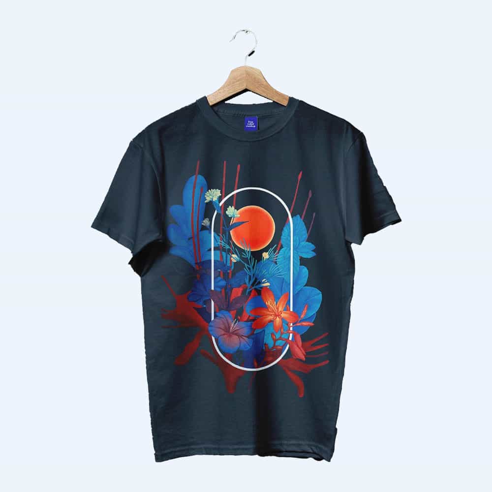 Black T-shirt hanging on a wooden hanger, featuring a vibrant graphic design of blue and red floral elements, a red sun, and abstract shapes framed by a white oval outline.