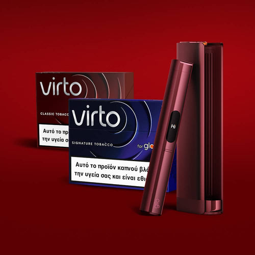 Two Virto tobacco product boxes with Greek text and health warnings are shown on a red background, alongside a sleek, dark red electronic device and its matching case.