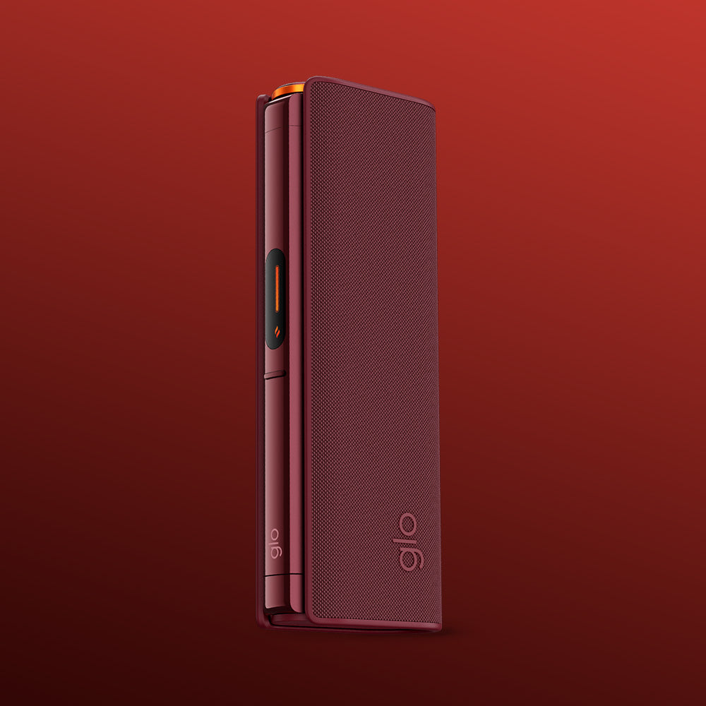 The glo™ HILO Plus Sleeve, a sleek maroon electronic device case with "glo" printed near the bottom of its premium fabric cover, stands upright against a gradient red background.