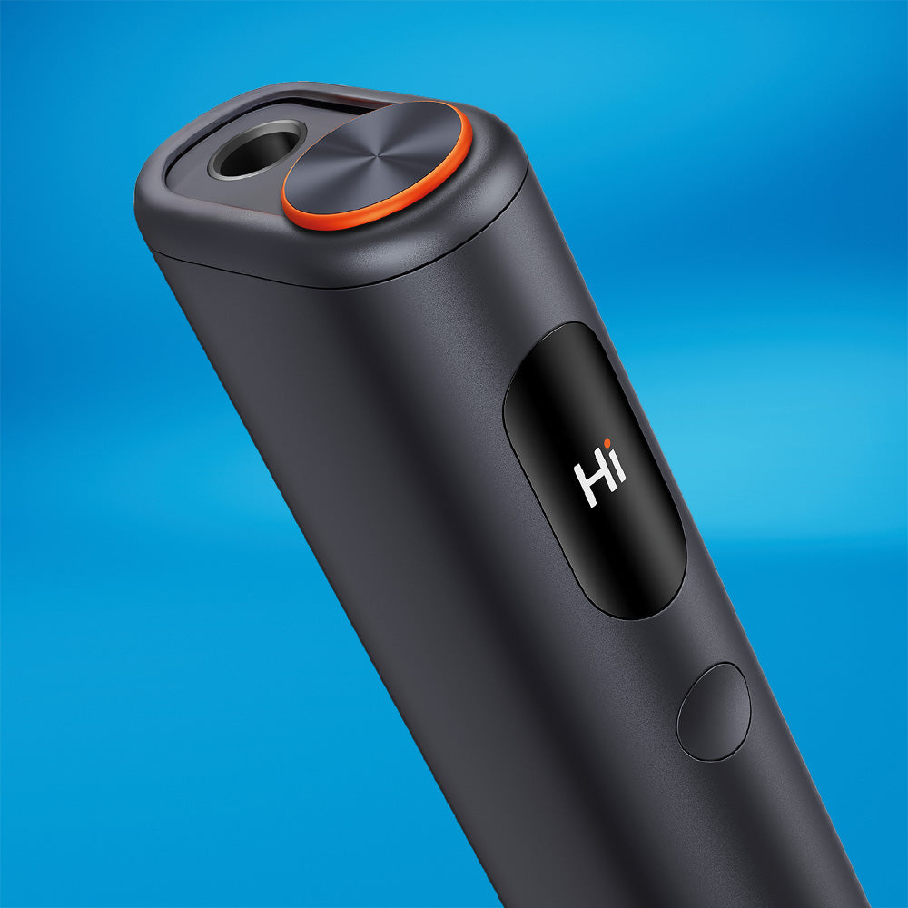 A close-up of the glo™ HYPER PRO+, a sleek black device with a circular orange accent, button, and a display screen that shows "Hi" on a blue background.