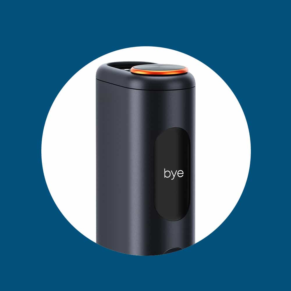 A close-up of a sleek, black electronic device with a rounded top and an orange accent. The display on the front shows the word bye. The device is centered on a white circle with a blue background.