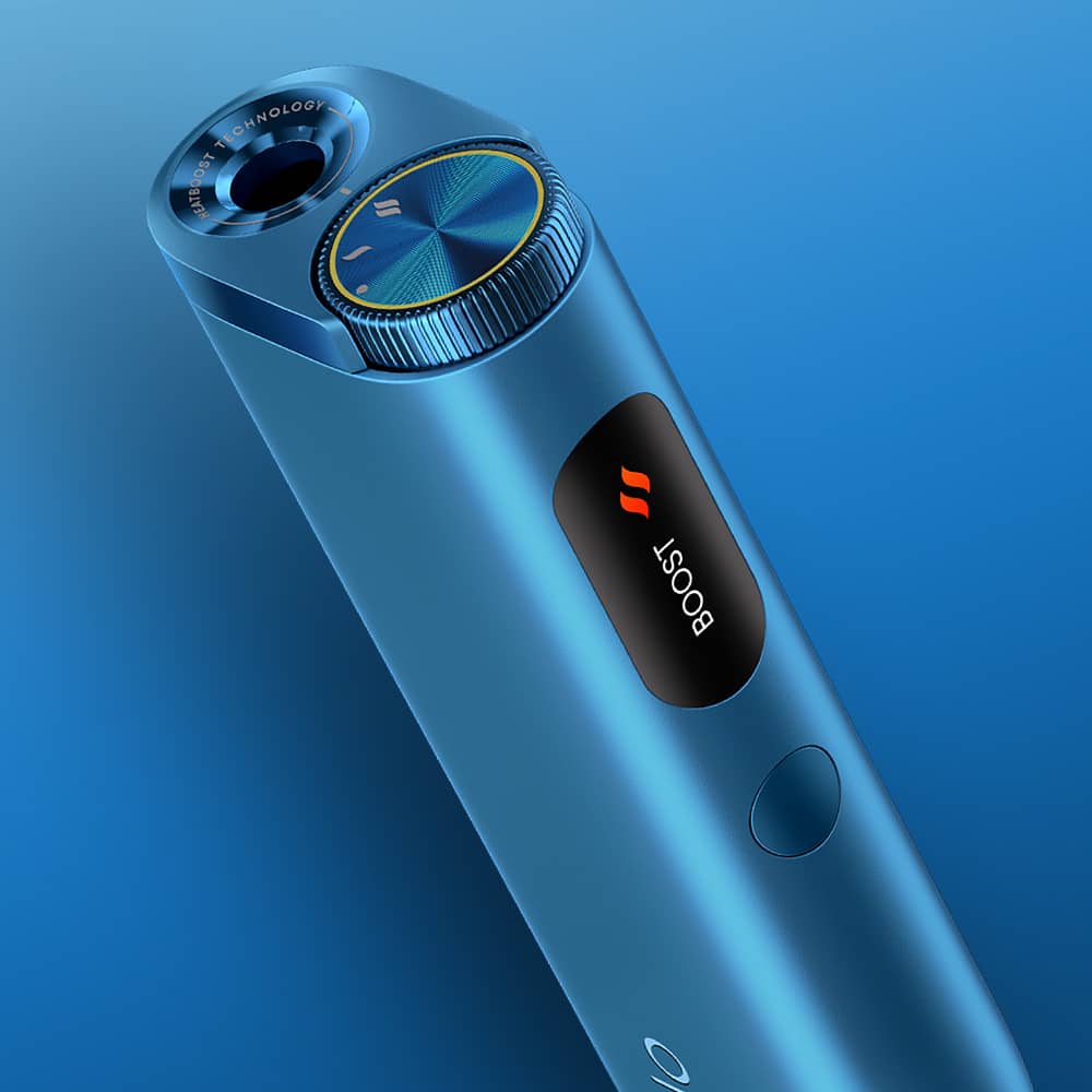 A close-up of a sleek, metallic blue electronic device with a circular dial, a small screen displaying the word BOOST with an orange icon, and a button below, all set against a blue gradient background.