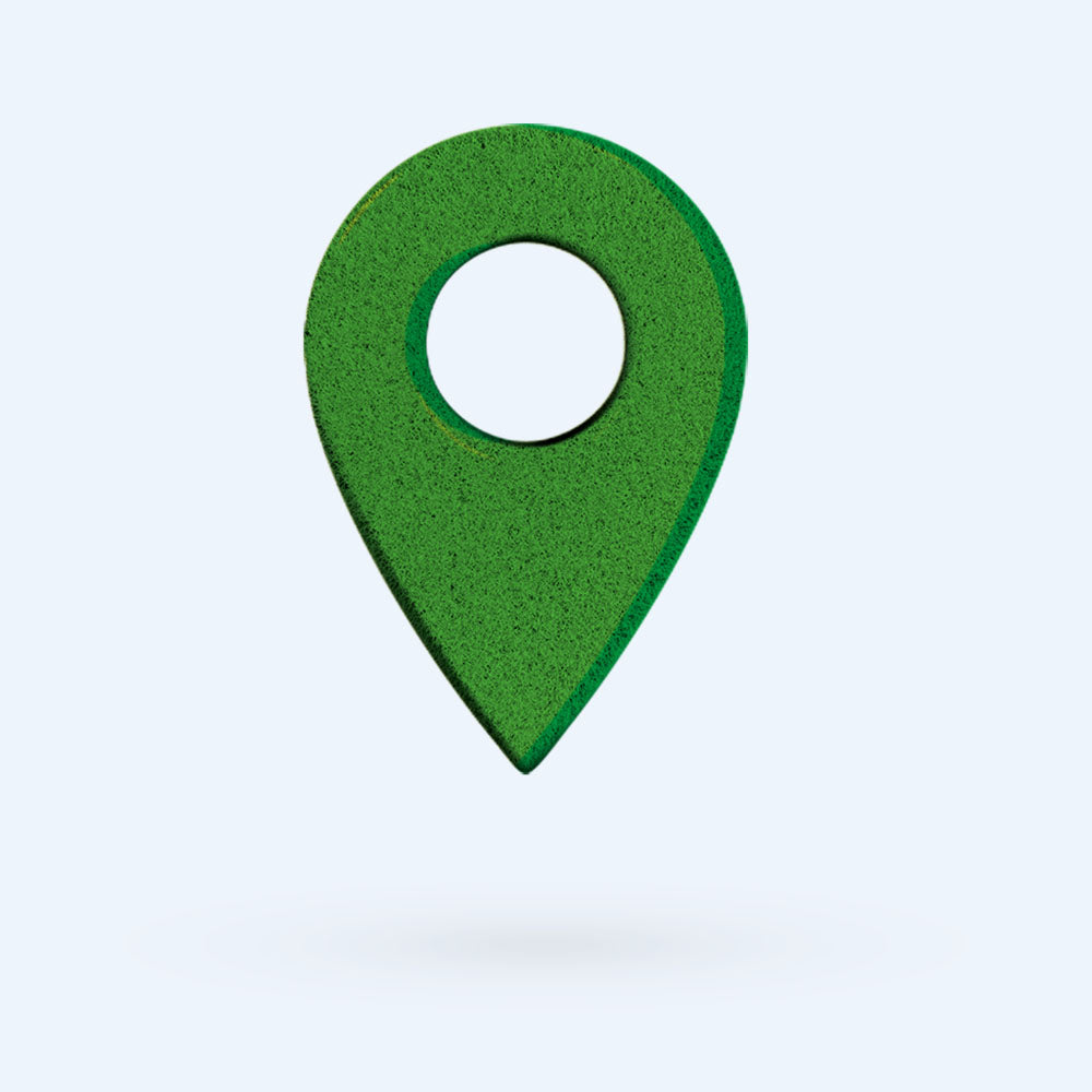 A green map location pin icon with a circular hole in the center, floating above a light gray background with a faint shadow below it.