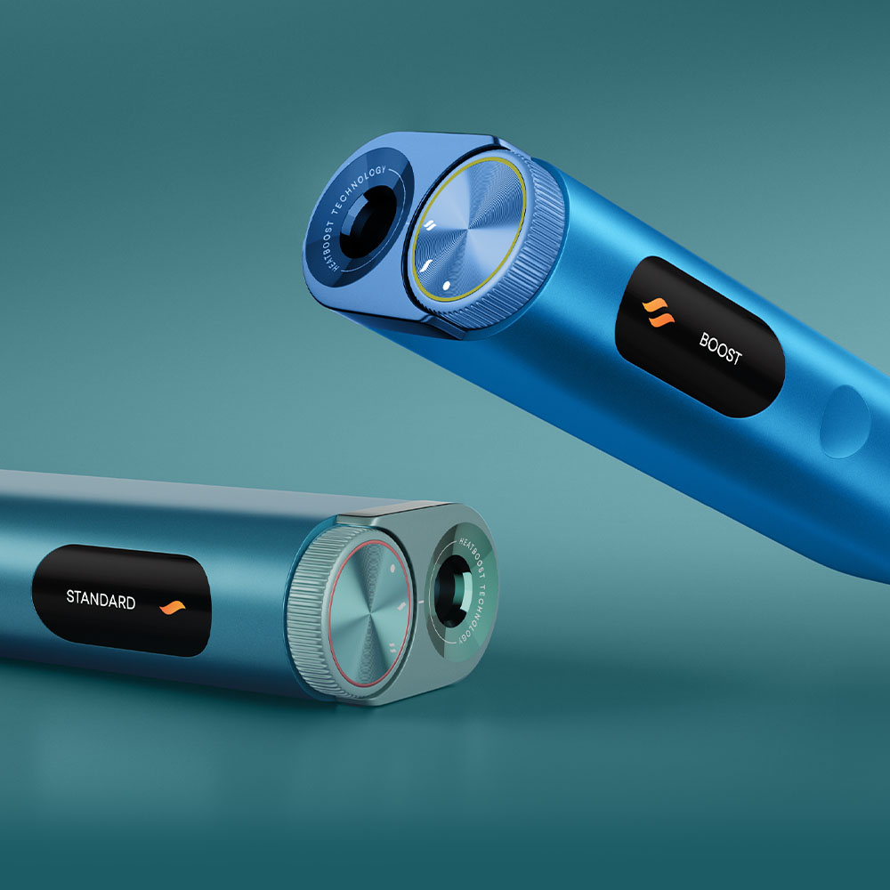 Two metallic blue cylindrical electronic devices with digital displays, labeled STANDARD and BOOST, featuring textured control dials and a sleek, modern design against a teal background.